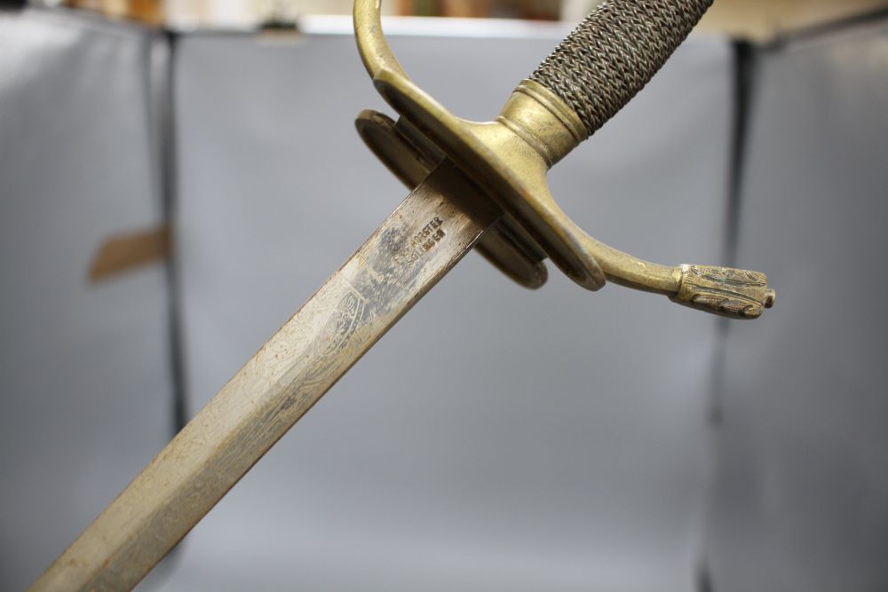 A cut steel dress sword by Ede & Ravenscroft of London and two brass hilted dress swords